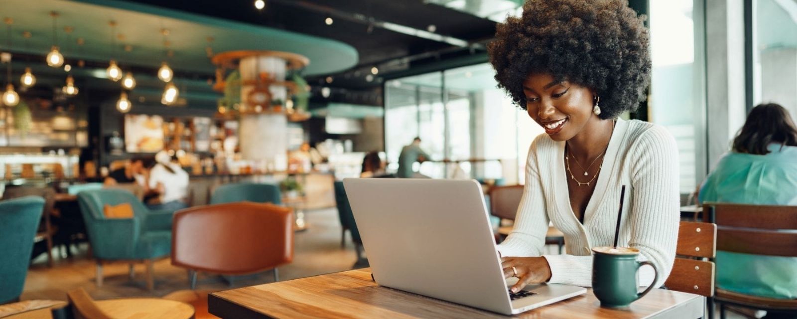 Small Business Owner working at her computer in a coffee shop